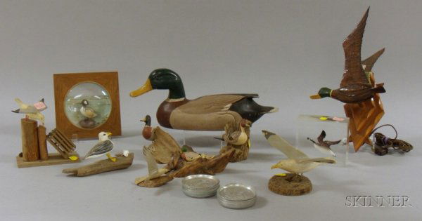 Twenty-seven Duck and Seagull Figural and Themed I: Twenty-seven Duck and Seagull Figural and Themed Items, a tile-top iron table, fifteen aluminum coasters, nine wooden seagull and duck figures, a goose figure, and a mallard decoy.
