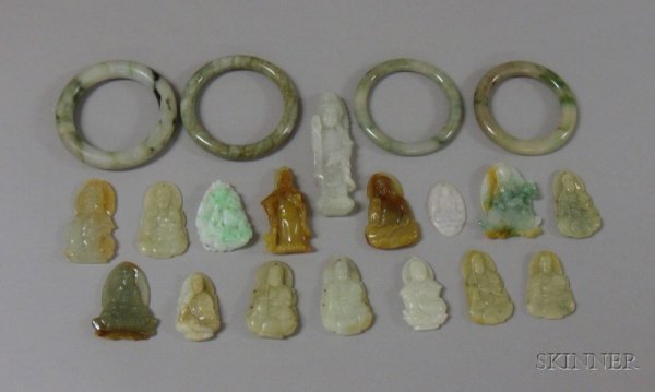 Twenty Carved Jade Pendants and Other Items, of va: Twenty Carved Jade Pendants and Other Items, of various forms including pendants, bangles, a green standing deity, and a green and white figure of a seated man.