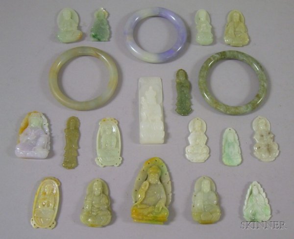 Seventeen Carved Jade Pendants and Three Jade Bang: Seventeen Carved Jade Pendants and Three Jade Bangles, in various forms including a green and tan seated figure, a white rectangular seated Buddha pendant, a purple and green seated figure, a white an