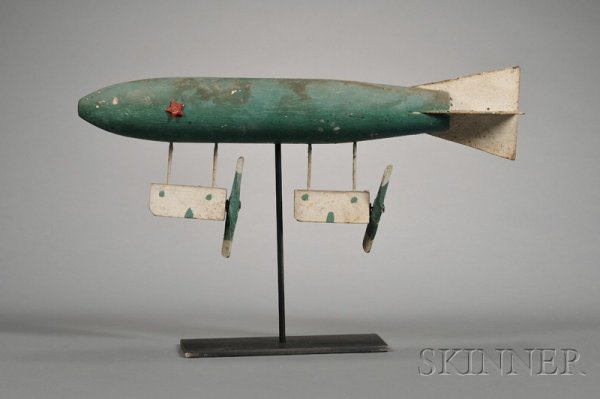 Carved and Painted Wood and Metal Dirigible Whirli: Carved and Painted Wood and Metal Dirigible Whirligig, America, probably early 20th century, with carved wooden propellers, applied metal stars, including stand, overall ht. 10 7/8, lg. 17 1/4 in.