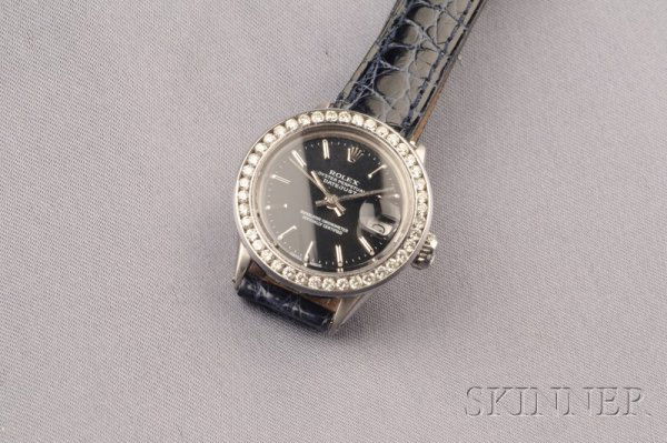 Lady's Platinum Wristwatch, Rol: Lady's Platinum Wristwatch, Rolex, Oyster Perpetual Datejust, the black dial with baton numeral indicators, date aperture, with later 18kt white gold and diamond bezel, enclosing automatic movement, c