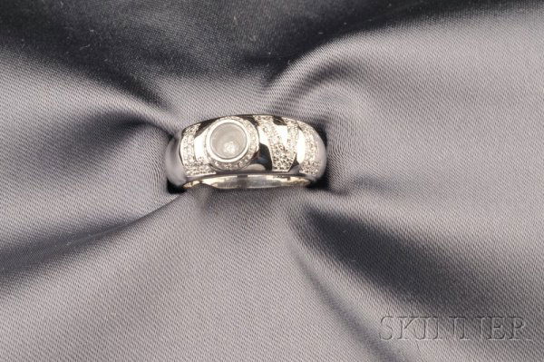 18kt White Gold and Diamond "Love" Band, Chopard,: 18kt White Gold and Diamond "Love" Band, Chopard, the band reading LOVE in diamond melee and centering a Happy diamond, size 7, signed.