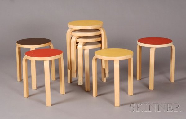 Eight Alvar Aalto Low Stools Birch and laminate Fo: Eight Alvar Aalto Low Stools Birch and laminate Fourth quarter 20th century Circular tops in the following colors: two in mustard, two in red, one black, and four beige, all raised on three bent birch