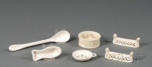 Six Staffordshire Glazed Earthenware Items, England: Six Staffordshire Glazed Earthenware Items, England, late 18th/early 19th century, consisting of five creamware items, two pierced knife rests with scrolled ends, lg. 4 1/4 in.; a coaster with pierced