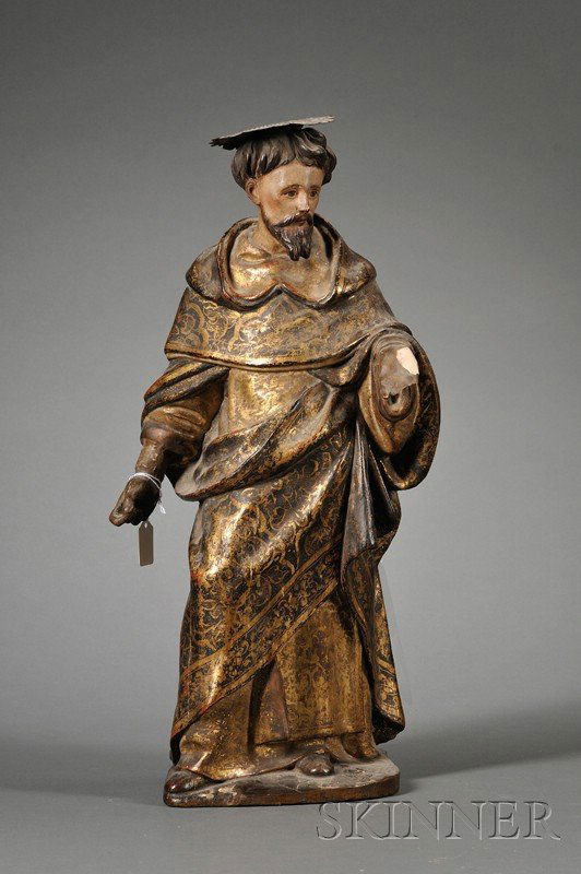 Continental Polychrome Wood and Gesso Figure of a: Continental Polychrome Wood and Gesso Figure of a Monk Saint, 18th/19th century, the standing figure in black and gold painted robes, mounted with a later pressed metal nimbus, ht. 21 in.