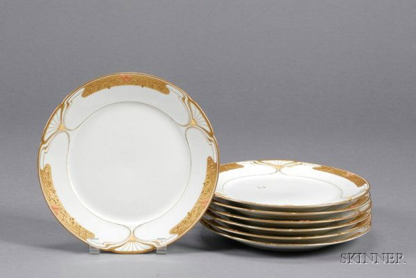 Seven Art Nouveau Style KPM Porcelain Plates, Germ: Seven Art Nouveau Style KPM Porcelain Plates, Germany, late 19th/early 20th century, each with raised gold border decorated with stylized foliage and "jeweled" with buff and pink enamels, printed mark