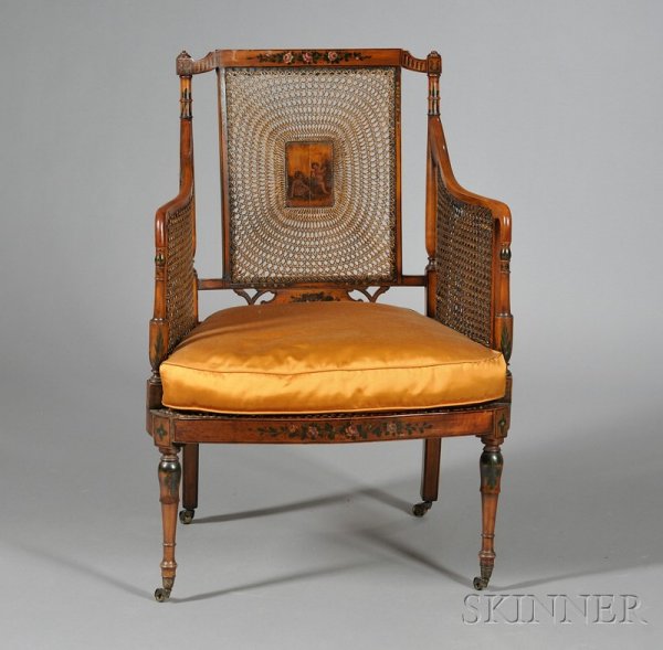 Edwardian Style Polychrome Painted and Caned Fruit: Edwardian Style Polychrome Painted and Caned Fruitwood Armchair, with caned back and sides, decorated with scenes of cherubs and foliate sprays, on circular legs, seat ht. 18 in.