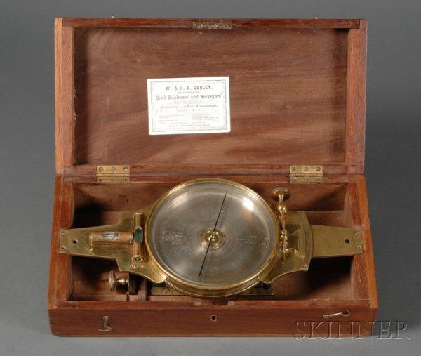 Brass Surveyor 's Compass by W. & L. E. Gurley, Tr: Brass Surveyor 's Compass by W. & L. E. Gurley, Troy, New York, 6 1/4 in. dia. silvered dial with compass bearings in block letters, fleur-de-lis and signed W. & L. Gurley at North, needle ring calibr