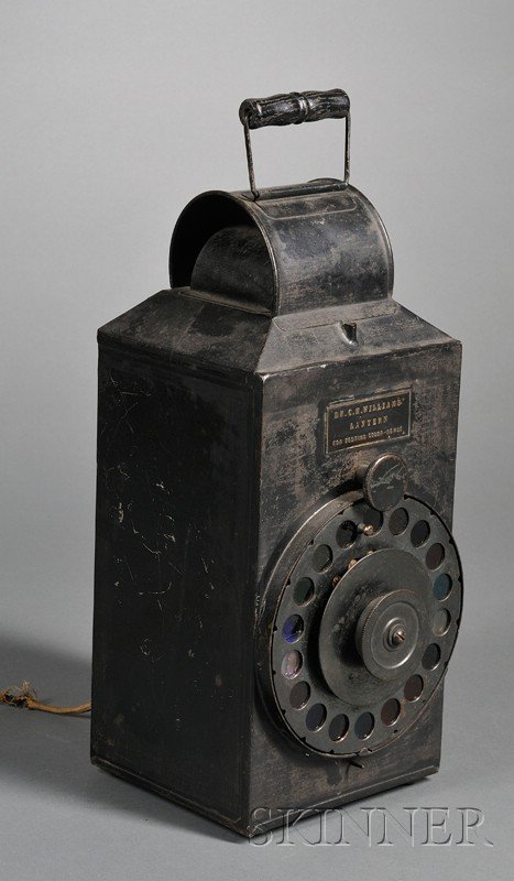 Tin Opthalmic Lantern by Dr. C.H. Williams, color : Tin Opthalmic Lantern by Dr. C.H. Williams, color wheel with eighteen shades, applied tin plate stamped Dr. C. H. Williams Lantern for Testing Color Sense, electric light and carrying handle, ht. 16 i
