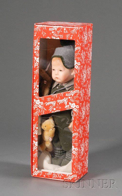 Boxed Kathe Kruse Replica 1913 "Jockerlie" Doll, c: Boxed Kathe Kruse Replica 1913 "Jockerlie" Doll, c. 1999, copy of early doll shape and construction, with molded and painted hair and features, wrist tag, one-piece green plush sleeveless suit, stripe