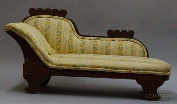 Doll's Chaise Longue, late 19th/early 20th century: Doll's Chaise Longue, late 19th/early 20th century, with stained pine frame, and cream and yellow floral printed upholstery, ht. 15 1/2 x lg. 30 in.