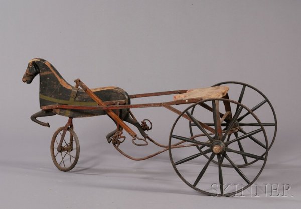Painted Wrought Iron and Wood Child's Ride-on Peda: Painted Wrought Iron and Wood Child's Ride-on Pedal Cart with Horse Figure, America, late 19th century, with handle for pulling and steering, (imperfections), ht. 20, wd. 20 1/2, lg. 43 in.