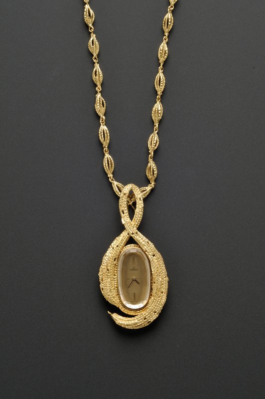 18kt Gold "About Time" Pendant Watch, Omega, Andre: 18kt Gold "About Time" Pendant Watch, Omega, Andrew Grima, c. 1969, the goldtone metal dial with baton numeral indicators, enclosing manual-wind 17-jewel movement no. 32396686, case no. 8260, Swiss gu