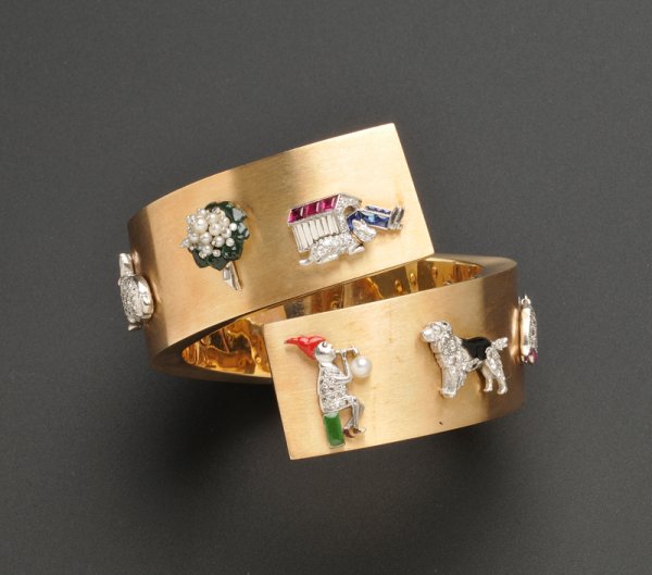 14kt Gold and Gem-set Charm Bypass Bracelet, c. 19: 14kt Gold and Gem-set Charm Bypass Bracelet, c. 1940, the hinged form with eight Art Deco enamel and gem-set charms including champagne in a cooler, a bunny rabbit, two flower bouquets, a husband in a