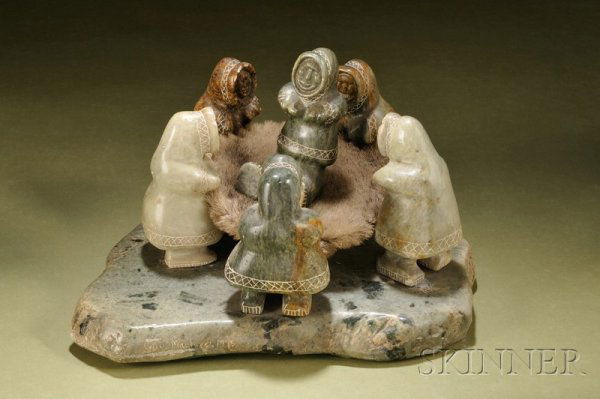 Inuit Soapstone Carving, 20th century, depicting f: Inuit Soapstone Carving, 20th century, depicting five women throwing a sixth into the air on a fur robe, signed Guy Maclure 1995, lg. of base 13 1/2 in.