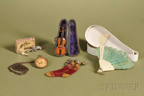 Group of Doll Accessories, late 19th century, incl: Group of Doll Accessories, late 19th century, including French miniature toy pistol with original box, miniature violin in case, sock-shaped purse, and a miniature toy pocket watch, (very good).