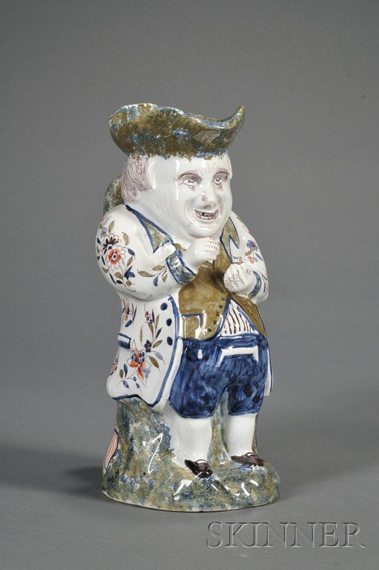 French Faience Snuff-taker Toby Jug, France, c. 19: French Faience Snuff-taker Toby Jug, France, c. 1900, polychrome enamel decorated with a floral decorated long coat and sponged hat, handle and base, ht. 11 1/8 in.