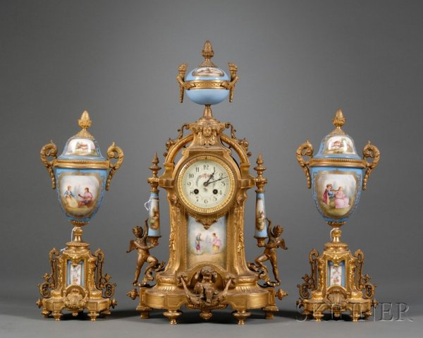 Assembled Three Piece Sevres-style Porcelain and G: Assembled Three Piece Sevres-style Porcelain and Gilt Metal Clock Garniture, France, early 20th century, each with celeste blue ground and enameled cartouches, a pair of vases with fixed covers, ht. 1