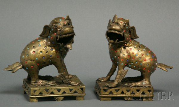 Pair of Bronze Foo Dogs, Tibet or Nepal, early 20th: Pair of Bronze Foo Dogs, Tibet or Nepal, early 20th century, surfaces inset with coral, jet, and turquoise-colored glass, ht. 8, lg. 7 in.