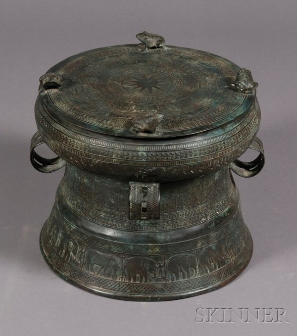 Bronze Drum, Southeast Asia, 20th century, Dong Son: Bronze Drum, Southeast Asia, 20th century, Dong Son style, cast with four frogs, four rings, and the surface covered with figures and geometric motifs, ht. 13, dia. 15 in.