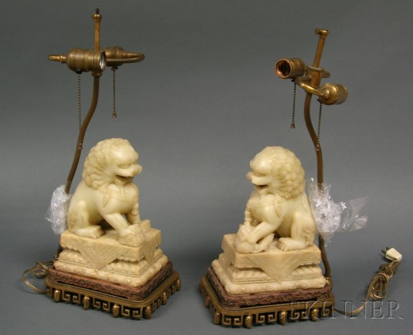 Pair of Soapstone Buddhist Lions, China, 19th cent: Pair of Soapstone Buddhist Lions, China, 19th century, stone of a yellow wax color, fitted hardwood stands mounted as lamps, ht. 9, lg. 6 3/4 in.