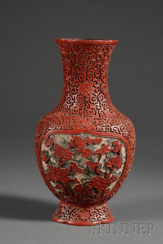 Three-Color Cinnabar Vase, China, late 19th/early: Three-Color Cinnabar Vase, China, late 19th/early 20th century, lobated flattened pear shape with a flaring mouth and neck, surface carved with reserves of flowers and butterflies on a stylized lotus
