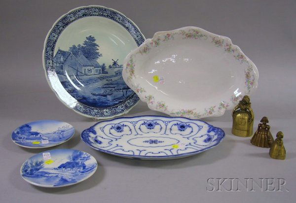 Five Assorted Decorated Ceramic Items and Three Fi: Five Assorted Decorated Ceramic Items and Three Figural Brass Bells, a P. Regout Royal Sphinx transfer Dutch landscape plaque, a Limoges porcelain platter, an English Flow Blue Beaufort pattern platte