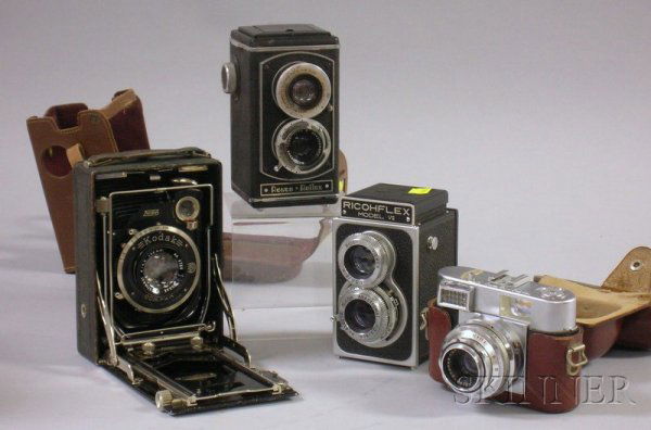 Four Vintage Cameras, including two twin-lens refl: Four Vintage Cameras, including two twin-lens reflex cameras, one Model VII by Ricohflex, the other a Royce Reflex, a 35mm Vitomatic range finder camera and leather case and a Kodak bellows folding ca