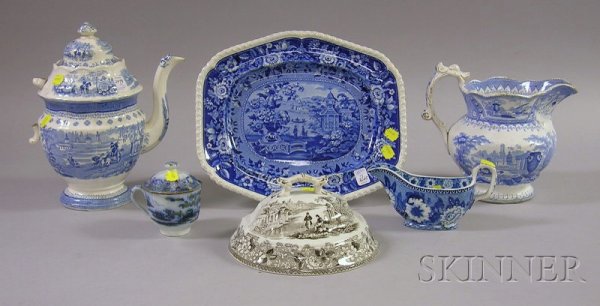 Six Staffordshire Ceramic Tableware Items, five i: Six Staffordshire Ceramic Tableware Items, five in blue and white, including a sauceboat, a lidded teacup, a tray, a pitcher, and a lidded coffeepot (handle broken off), together with a black and whit