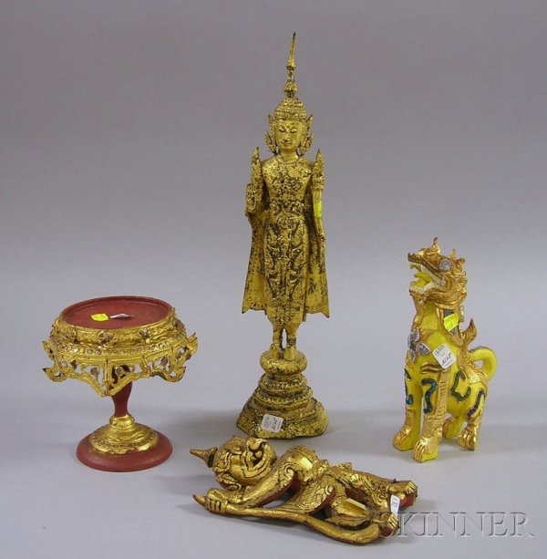 Four Southeast Asian Gilt Items, gilt-metal image : Four Southeast Asian Gilt Items, gilt-metal image of a standing female, a wooden painted dragon/mythical beast, a hanging mystical figure, and a wooden stand, ht. to 19 in.