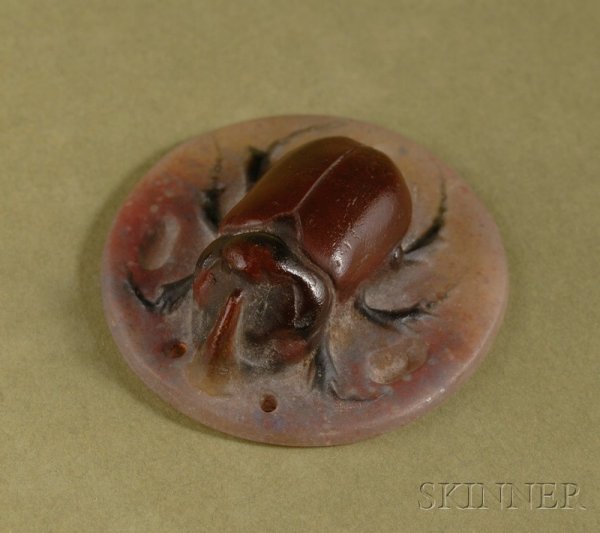 Small French Pate de Verre Medallion, early 20th c: Small French Pate de Verre Medallion, early 20th century, circular format, with raised figure of a brown beetle on a beige and lightly tinged purple ground, dia. 1 3/4 in.