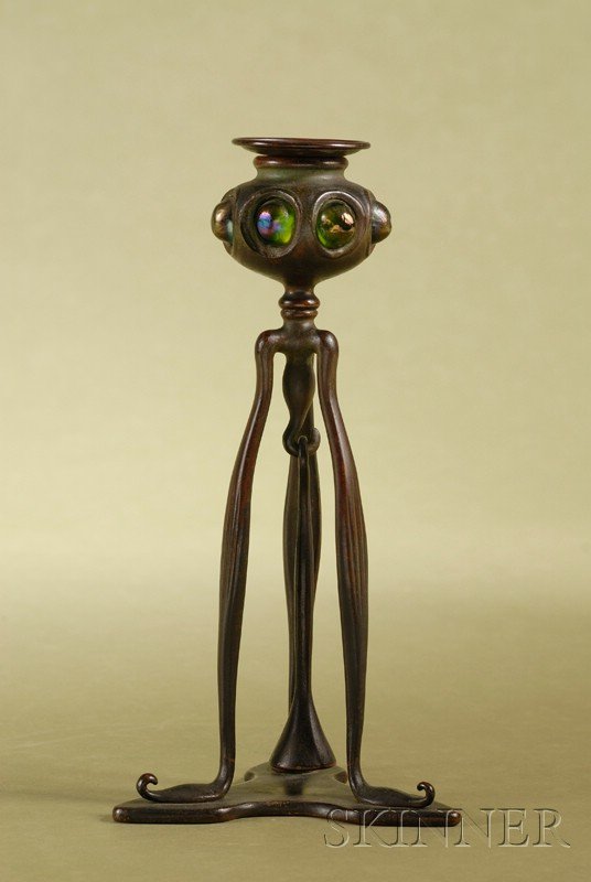 Tiffany Studios Favrile Glass-mounted Bronze Candl: Tiffany Studios Favrile Glass-mounted Bronze Candlestick and Snuffer, early 20th century, circular drip pan and nozzle, with cabochon style glass pieces, on three foliate-shaped legs joined by a shape