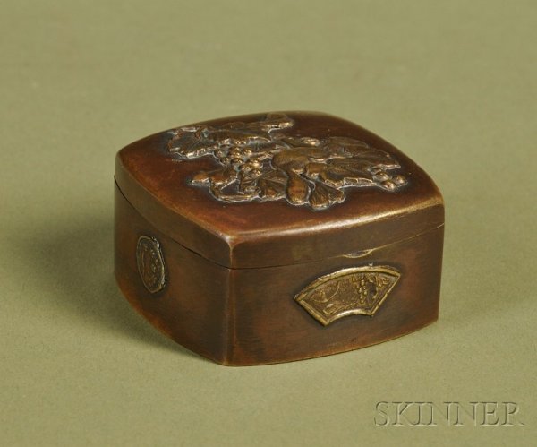 Japanese Mixed Metal Snuff Box, late 19th century,: Japanese Mixed Metal Snuff Box, late 19th century, with slightly bowfronted sides, the top with a scene of a squirrel amidst branches and nuts, the sides with decorative circular and fan-shaped bosses