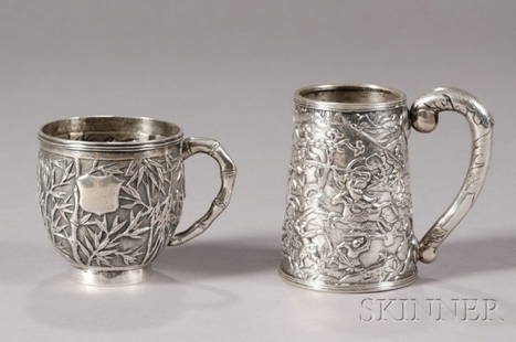 Two Chinese Export Silver Mugs, c. 1850, one with t: Two Chinese Export Silver Mugs, c. 1850, one with tapered straight sides and leaf scroll handle decorated with a chased battle scene, the other with repousse bamboo decoration and handle, ht. 3 5/8 ,