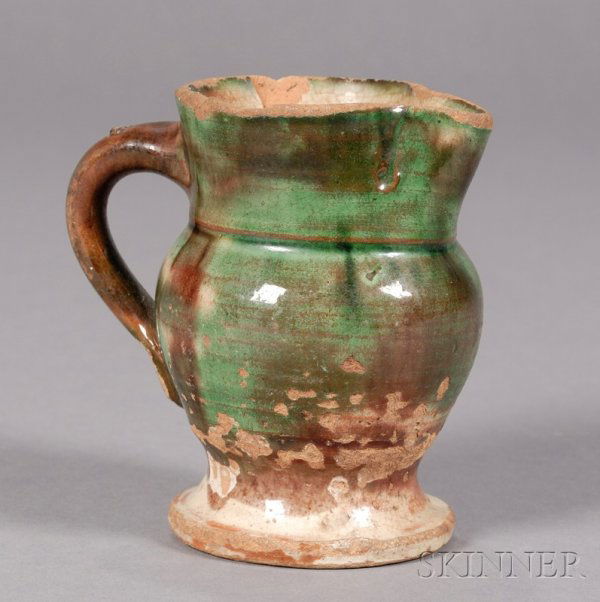 Small Redware Pitcher, America, early 19th century: Small Redware Pitcher, America, early 19th century, with mottled, green, brown and cream-colored glaze, (glaze loss and chips), ht. 4 1/4 in.