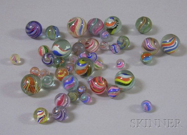 Forty-five Latticino Glass Marbles, including sol: Forty-five Latticino Glass Marbles, including solid core, ribbon, spiral with goldstone, etc., (imperfections), approx. dia. 3/8 to 1 in. Provenance: The collection of Charlotte Morse.