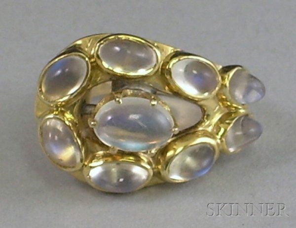 14kt Gold and Moonstone Ring, comprised of nine ca: 14kt Gold and Moonstone Ring, comprised of nine cabochon moonstones, accompanied by appraisal, size 4.