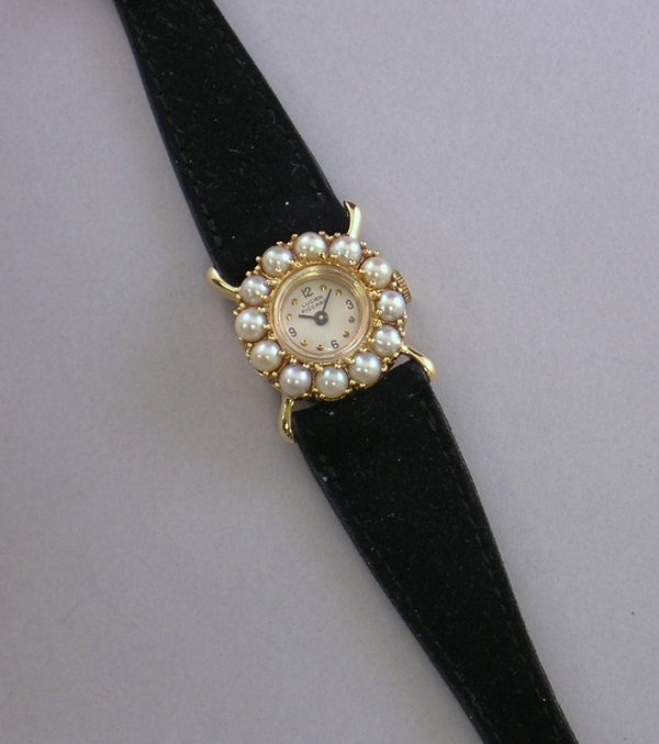 14kt Gold and Pearl Lucien Piccard Lady's Wristwat: 14kt Gold and Pearl Lucien Piccard Lady's Wristwatch, on a black leather band, in original box.