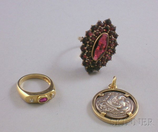 Three Gold Jewelry Items, a 14kt gold, ruby, and d: Three Gold Jewelry Items, a 14kt gold, ruby, and diamond ring, size 6 1/2, a 14kt gold and garnet ring, size 8 1/2, and an 18kt gold-framed antique coin pendant.