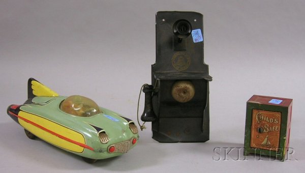 Three Metal Toys, "Baby Bell" painted tin wall tel: Three Metal Toys, "Baby Bell" painted tin wall telephone, a Japanese tin friction car, and a lithograph and painted tin "Child's Safe" bank.