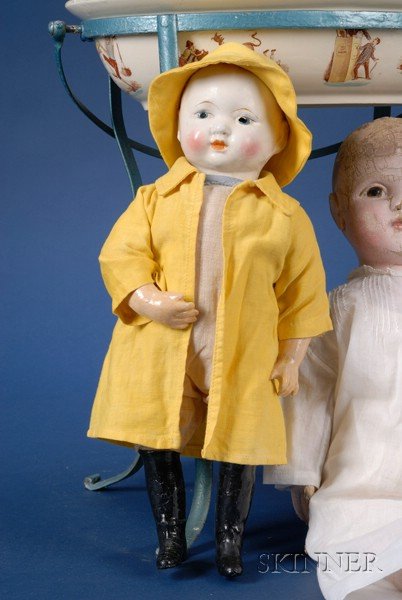Ideal Composition "Uneeda Biscuit Boy," 1914-19, w: Ideal Composition "Uneeda Biscuit Boy," 1914-19, with molded and painted head, lower arms and black booted feet, excelsior-stuffed cotton body, dressed for the rain in yellow cotton raincoat and sweat