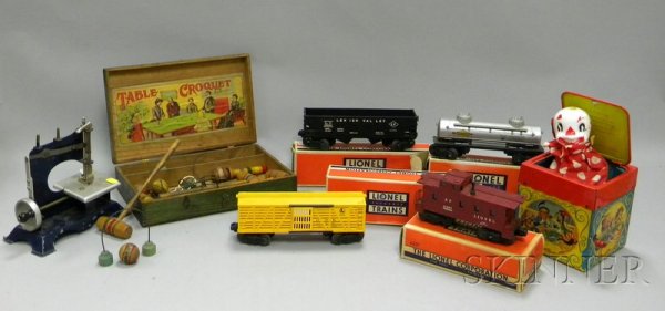 Seven Toys, four Lionel train cars, table croquet: Seven Toys, four Lionel train cars, table croquet set in case, child's lithographed sewing machine, and a Mattel jack-in-the-box.