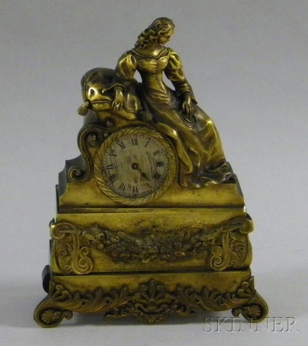 French Bronze Mantel Clock, with female figure su: French Bronze Mantel Clock, with female figure surmounting the 2 1/4 in. dia. silvered dial with Roman numerals, applied garlands and scrollwork feet, eight-day lever escapement timepiece movement, (r