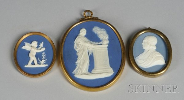 Three Wedgwood and Bentley Blue Jasper Medallions,: Three Wedgwood and Bentley Blue Jasper Medallions, England, c. 1775, each oval and with applied white relief, with depictions of a cupid with a bird and nest, lg. 2 1/8; a maiden by a sacrificial alta