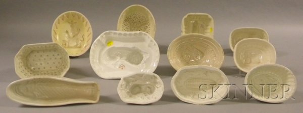 Twelve English Creamware Culinary Molds, various sh: Twelve English Creamware Culinary Molds, various shapes, subjects include fish, corn and figures, grapes, elephant, Egyptian revival, two recumbent lion, bouquet, reeded, floral, and rabbit, lg. 4 3/4