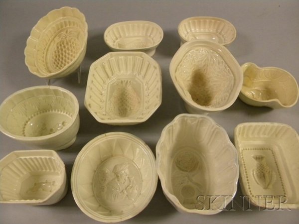 Eleven English Creamware Culinary Molds, various sh: Eleven English Creamware Culinary Molds, various shapes, subjects include rose and thistle, three pineapple, rabbit, fish, elephant, cherubs, goat, men drinking, and a bush, lg. 5 7/8 to 9 1/2 in.