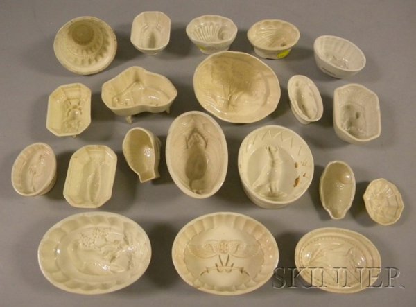 Twenty English Creamware Culinary Molds, various s: Twenty English Creamware Culinary Molds, various shapes, subjects include tulip, cauliflower, two shell, two Egyptian revival, crow, stag, rabbit, three floral, two fish, nut, sparrow, two small bird,