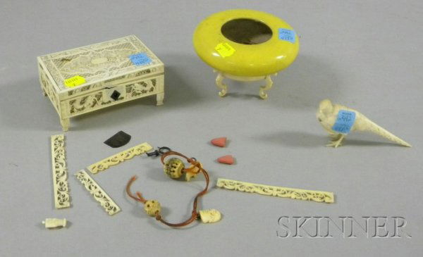 Three Chinese Porcelain and Ivory Decorative Objec: Three Chinese Porcelain and Ivory Decorative Objects, a small yellow porcelain bowl on stand, an ivory bird carving, and a small ivory box containing an assortment of small ivory pieces and beads, (da