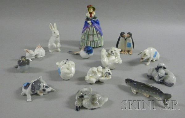 Thirteen Royal Copenhagen Animal Figurines and a R: Thirteen Royal Copenhagen Animal Figurines and a Royal Doulton Figure of a Victorian Lady, including three polar bear cubs, a pig, a pair of penguins, a pair of sleeping sheep, a bluebird, a pair of p