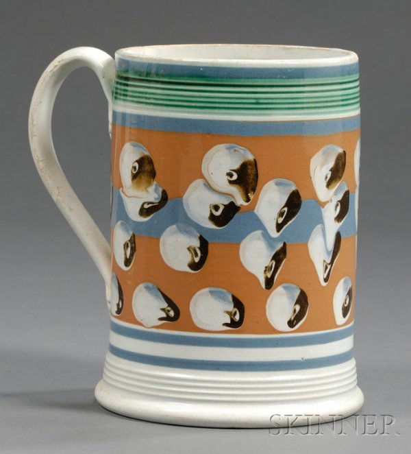 Mochaware Quart Mug with Cat's-eye Decoration, Bri: Mochaware Quart Mug with Cat's-eye Decoration, Britain, c. 1830, pearlware mug with reeded green rim and base, and bands of blue and rust and medial band with rows of blue, white, and black cat's-eyes
